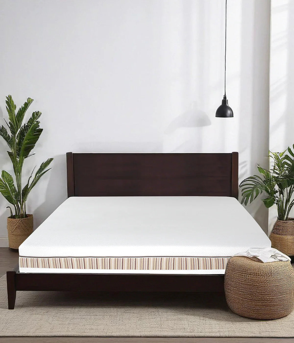 Venti two sided organic latex mattress shown without sheets on a tosca wood bed frame in a minimalist bedroom featuring beautiful palm trees.