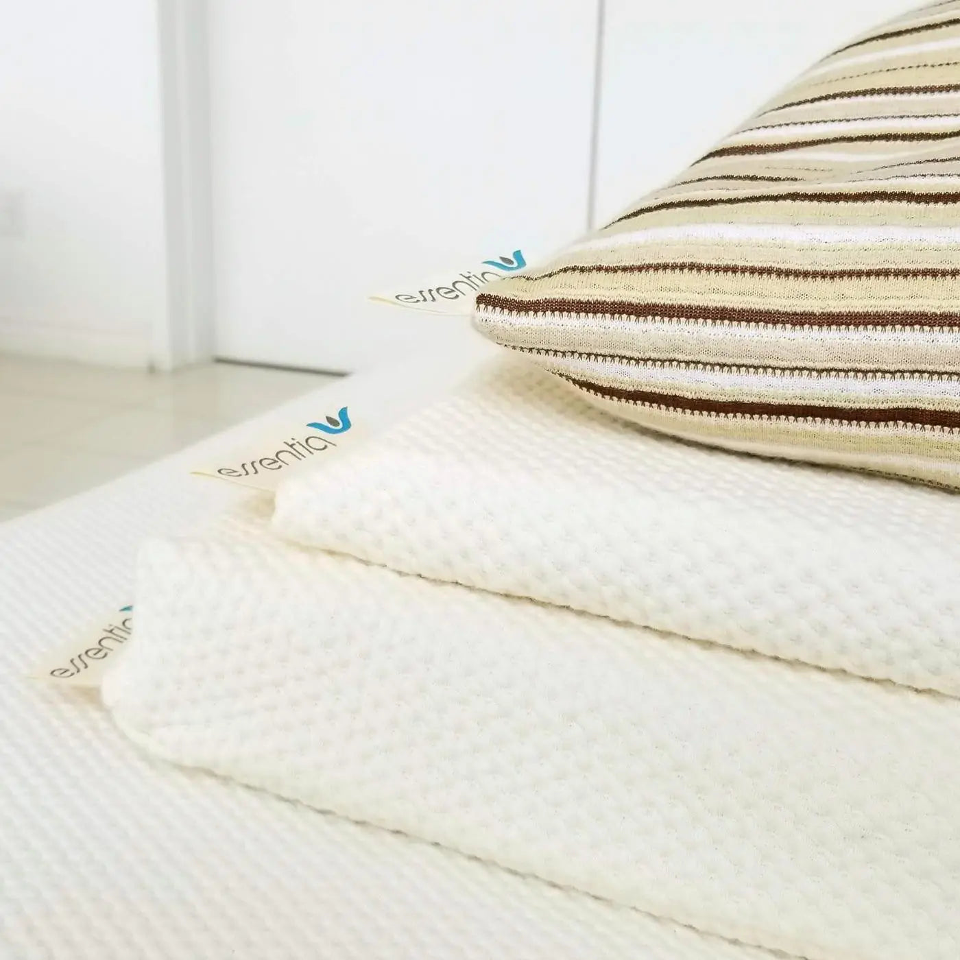 Close up of the corners of the Dorm IQ organic foam toppers with a Comfort pillow on top