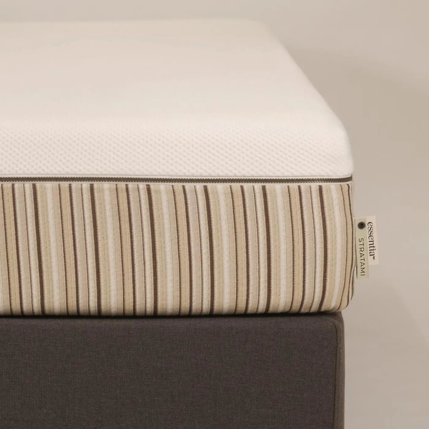 Close up of the corner of an Essentia Stratami organic mattress shown on the Vertebase foundation